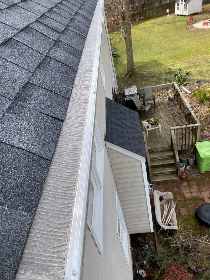 Gutter guard installed neatly along a residential roof edge